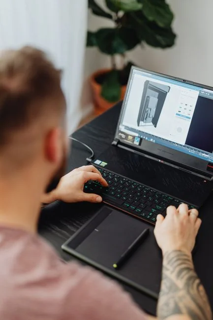 A dedicated designer concentrating on a user-focused project within a sleek office workspace.
